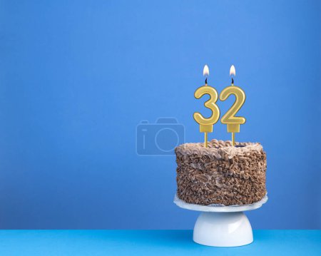 Birthday cake with candle 32 - Invitation card on blue background
