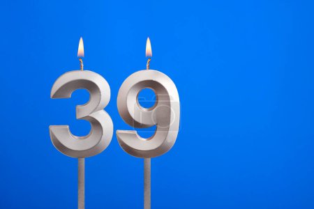 Birthday candle number 39 - Celebration card on blue background