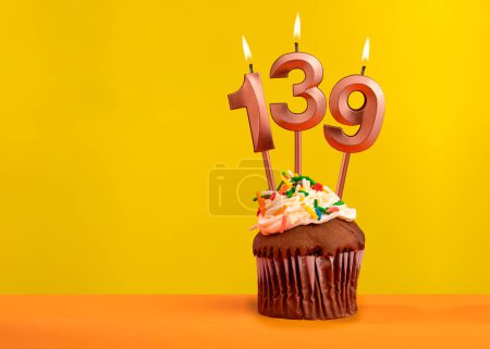 Candle with flame number 139 - Birthday card on yellow background