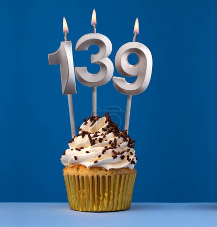 Burning candle number 139 - Birthday card with cupcake on blue Background