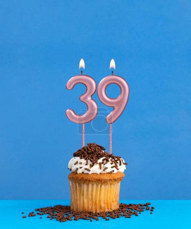 Birthday candle with cupcake on blue background - Number 39