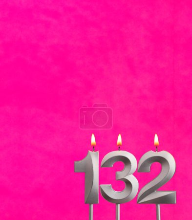 Photo for Candle 132 with flame - Birthday card in fuchsia background - Royalty Free Image
