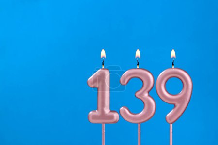 Birthday card with number 139 - Burning anniversary candle on blue background
