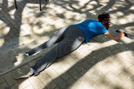 Woman with alcohol addiction problems asleep in a public space in a park