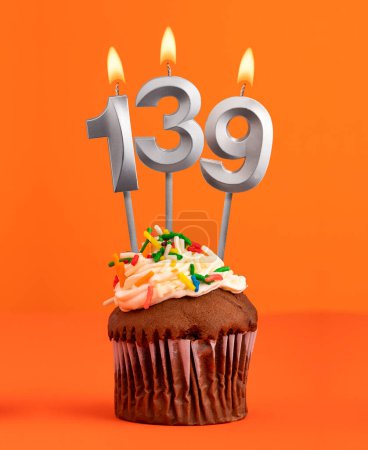 Number 139 candle - Birthday cupcake on orange background