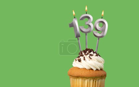 Birthday with number 139 candle and cupcake - Anniversary card on green color background