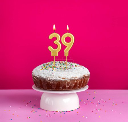 Birthday cake with number 39 candle on pink background