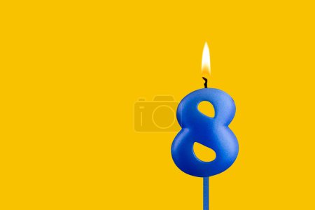 Blue candle number 8 - Birthday on yellow background