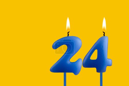 Blue candle number 24 - Birthday on yellow background