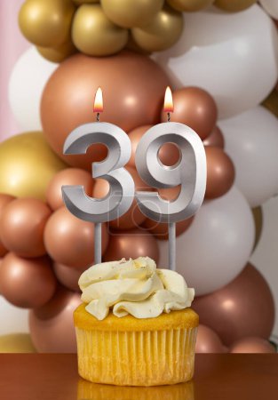 Cupcake with birthday candle on balloons background - Number 39