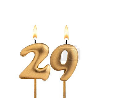 Goldene Kerze Nummer 29 - Geburtstag auf weißem Hintergrund