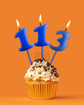 Blue candle number 113 - Birthday cupcake on orange background
