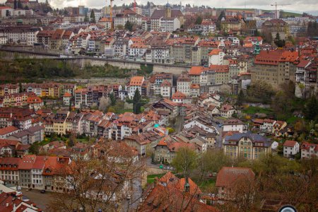 Panoramic view of Fribourg, a charming city blending old-world architecture and modern living, nestled along the serene Sarine River in Switzerland.