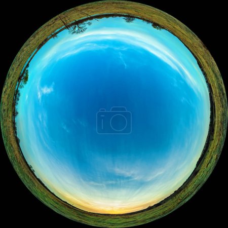 Panorama in fulldome photo format. Sunset and sky over the meadow in the evening. Circular fisheye view of a spring landscape in the countryside