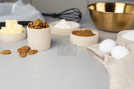 Photo for Close-up of the ingredients for brownie on a grey surface in the modern kitchen. Culinary blog. - Royalty Free Image