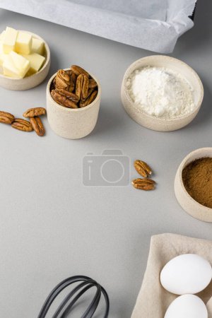 Photo for Brownie recipe ingredients and kitchen utensils on gray background, top view. - Royalty Free Image