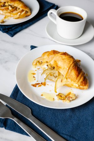 Téléchargez les photos : Café du matin avec croissants farcis à la poire caramélisée, noisettes et ricotta. - en image libre de droit