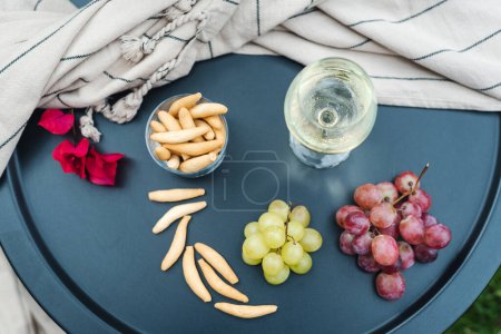 Photo for A glass of white wine with appetizers on the table. - Royalty Free Image