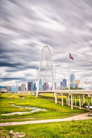 Photo for The Margaret Hunt Hill Bridge in Dallas, Texas stands as a stunning landmark amidst the cityscape, its long exposure and clouds contrasting against the built structure. High quality photo - Royalty Free Image