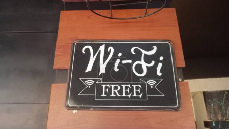 Photo for Wi-Fi FREE written on the black board. Wifi symbol. - Royalty Free Image