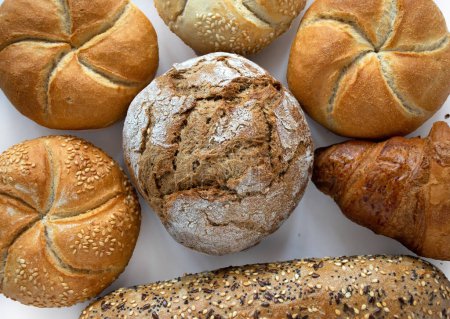 Photo for Assorted bakery products including loafs of bread and rolls - Royalty Free Image