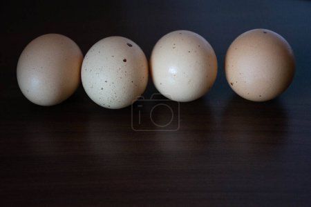 Photo for Farm eggs arranged on a black wooden background - Royalty Free Image