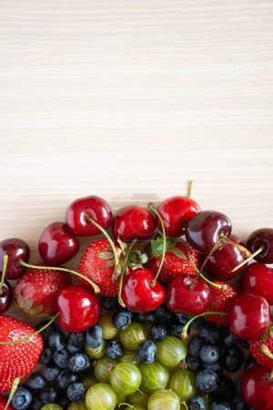 Photo for Berries variety, berries background with cherry fruits, strawberries, gooseberry and blueberries. Healthy eating lifestyle concept. - Royalty Free Image