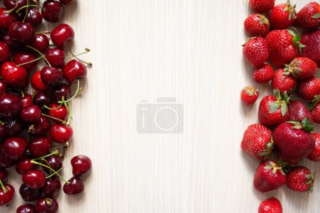 Photo for Cherry and strawberry fruits on a white wood background - Royalty Free Image