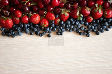 Photo for Berries variety, berries background with cherries, strawberries and blueberries. Healthy eating lifestyle concept on wood background. Space for text - Royalty Free Image
