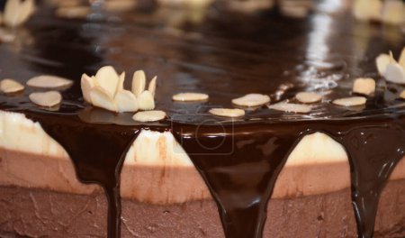 Photo for Triple chocolate mousse cake close up with chocolate mirror glaze and almond flakes. High quality photo - Royalty Free Image