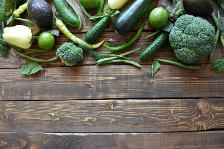Photo for Fresh green vegetables on light wood background. Dieting green organic vegetables - Royalty Free Image