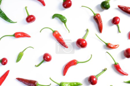 Photo for Hot chilli peppers pattern. Cayenne peppers isolated on white background. Fresno hot peppers pattern. Red and green peppers - Royalty Free Image