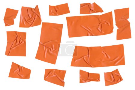 Adhesive plastic tape pieces on white background. Orange isolation scotch tape. Masking paper tape torn and wrinkled pieces set. High quality photo