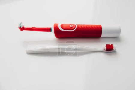 Photo for Red electric toothbrush on a white background - Royalty Free Image