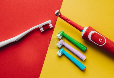 Photo for Electric toothbrush with colored nozzles on a colored background - Royalty Free Image