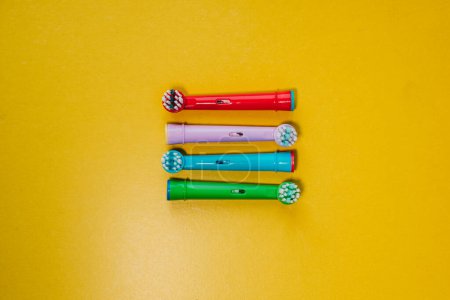Photo for Attachments for an electric toothbrush on a colored background - Royalty Free Image