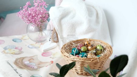 Composition of eggs painted for Easter in a basket and Gypsophila flowers. High quality photo
