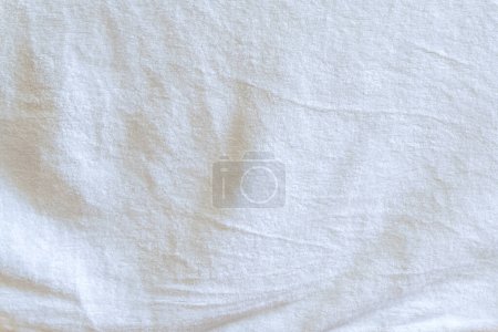 Wrinkled or crumpled white towel texture or background was taken with soft natural light used for clothing background or texture.
