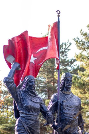 A statue of an Anatolian hero holding the Turkish flag high, alongside a female figure, 12 March 1918 symbolizing the liberation of Erzurum.