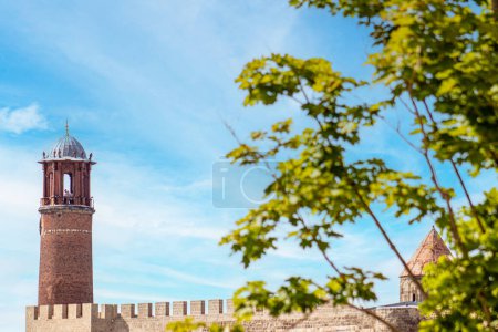 Erzurum Kalesi Saat Kulesi or Erzurum Castle clock tower stands against a serene blue sky. High quality photo