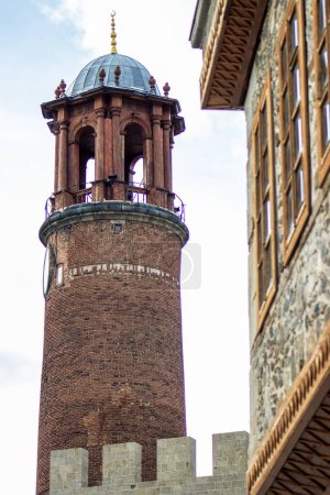 Erzurum Kalesi Saat Kulesi or Historic Erzurum Castle Clock Tower and stone house. 