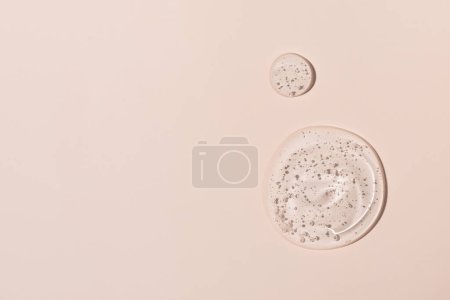 Photo for Abstract face serum texture. Skin care liquid gel on beige background. Transparent cosmetic face cream with bubbles for design. - Royalty Free Image