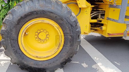 Photo for Close Up yellow wheels with black tires on a tractor - Royalty Free Image