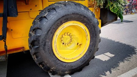 Photo for Close Up yellow wheels with black tires on a tractor - Royalty Free Image
