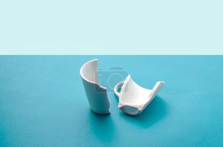 Photo for Cup broken in half, symbolizing the break and the end of something that was once whole. - Royalty Free Image