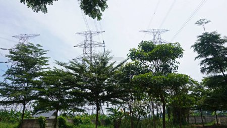 Photo for Landscape clouds sky above electric tower and electric power station at rural village. overcast weather climate change - Royalty Free Image