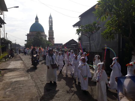 Photo for Surabaya, East Java, Indonesia - February, 2023 : Selective focus Elementary school children's parade in commemoration of the Prophet Muhammad's Isra and Miraj - Royalty Free Image