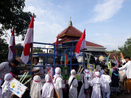 Photo for Surabaya, East Java, Indonesia - February, 2023 : Selective focus Elementary school children's parade in commemoration of the Prophet Muhammad's Isra and Miraj - Royalty Free Image