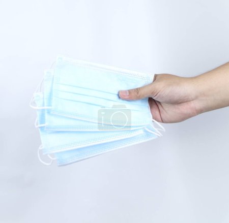 Photo for Hand holding medical mask isolated on a white background - Royalty Free Image