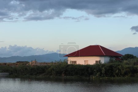 Photo for A house by the water with a red roof - Royalty Free Image